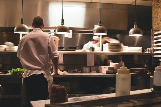 علی حدادیان chef standing in restaurant kitchen